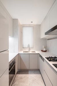 Modern minimalist kitchen with marble countertops and floor.