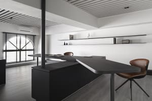 A modern office space featuring a dark wood counter with a sleek, minimalist design.