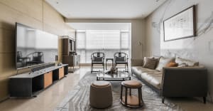 Modern living room with marble accents, leather sofa, and wooden furniture.