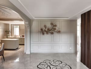 Modern living room featuring a botanical wall panel and a stylish marble floor with a swirling design.