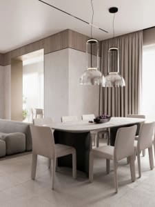 Modern minimalist dining room with a marble table, glass pendant lights, and fabric chairs.