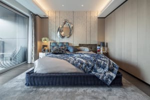 Modern bedroom with fabric furniture, minimalist design, and a combination of dark and light tones.