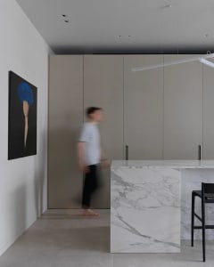 Modern residential kitchen featuring a striking marble countertop and minimalist design.
