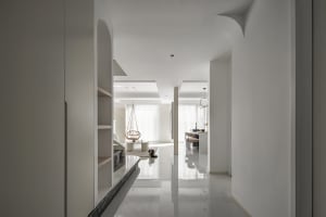 A contemporary living room with white marble flooring, minimalist decor, and a modern lamp.