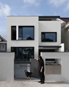 A modern, contemporary residential exterior with large windows and a minimalist design.