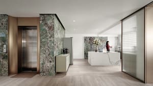 A modern living room featuring marble walls and flooring.