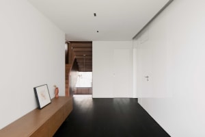 Modern minimalist interior design with minimalist furniture, wooden floors, and glass elements.