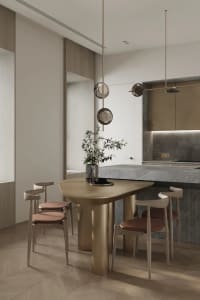 Modern kitchen with a dining table made of a combination of metal and marble, featuring minimalist design elements.
