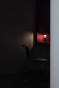 A minimalist office space featuring an industrial design aesthetic with metal fixtures.