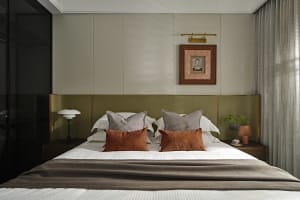 Contemporary bedroom with modern furniture, featuring fabric upholstery and minimalist design.