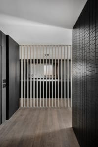 Modern industrial office space featuring minimalist design, metal and glass walls, and sleek furniture.