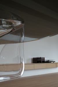 A well-designed living room featuring modern furniture made of glass with sleek lines and minimalist design.