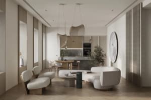 A modern minimalist living room with white furniture, a curved sofa, a coffee table, and a kitchen area in the background.
