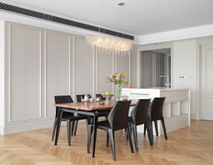 A modern dining room featuring a wooden table with silver teapot and vase of flowers, surrounded by black leather chairs, and