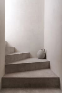 Concrete staircase adorned with a minimalist, modern vase