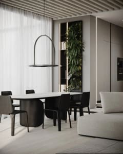 Modern residential dining room featuring a marble table, black chairs, and a hanging light fixture.