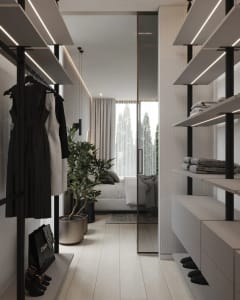 A modern plush walk-in closet with glass doors, metal shelving, and organized clothing items.