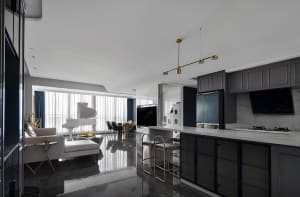 A modern kitchen with black marble flooring and cabinets