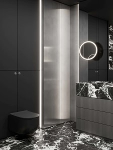 A modern bathroom with marble countertops and flooring, featuring dark cabinetry and a sleek, minimalist design.