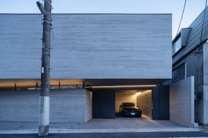 Modern car parked inside a minimalist concrete garage