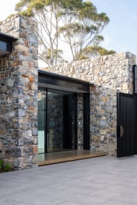 Modern house entry with stone wall and concrete flooring