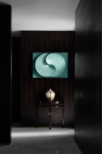 A modern entryway featuring minimalist metal circle artwork.