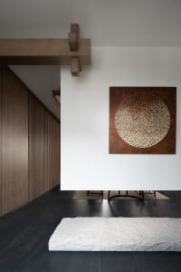 A modern interior space featuring wood paneling and a concrete floor