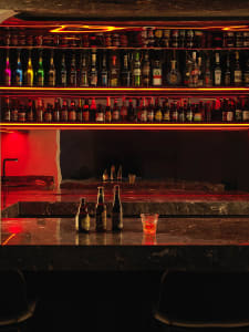 A bar counter with a dark, glossy marble top.