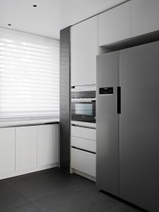 A contemporary kitchen with sleek metal appliances and minimalist design features.
