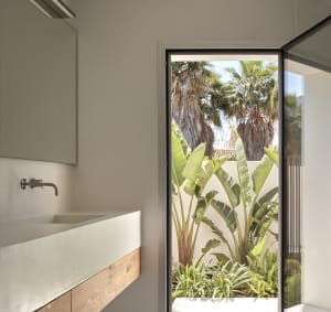 Minimalist bathroom with a concrete sink and wooden accents.