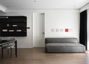 Modern living room featuring sleek leather furniture, wooden flooring, and glass accents.
