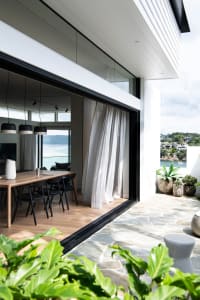 Modern residential interior featuring glass walls and stone flooring