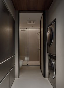 A minimalist laundry room with metallic finishes and a sleek, efficient design.
