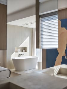 Modern bathroom featuring a minimalist design with concrete elements.