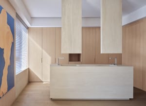 A modern kitchen with marble countertops and cabinets.