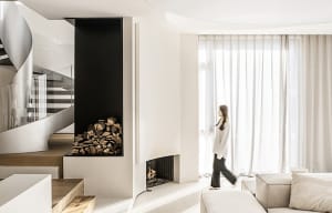 A minimalist living room with concrete walls and wooden furniture