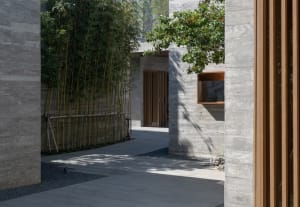 Concrete and wooden structure with bamboo fence and trees