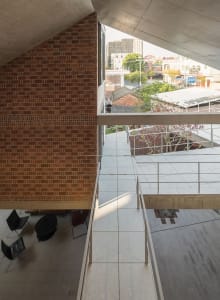 Industrial-style living space featuring glass walls and concrete surfaces