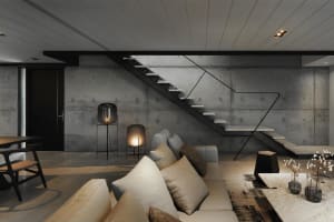 Modern industrial-style staircase with concrete walls and floor.