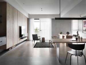 Modern living and dining room featuring concrete, wood, and textile materials
