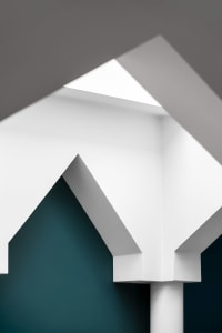 Architectural design featuring white geometric shapes against a blue background.
