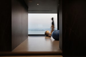 A minimalist workout room featuring marble flooring and equipment.