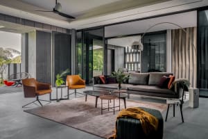 A modern contemporary living room featuring a mix of materials including leather sofas, glass coffee tables, and wooden floor