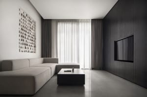 Modern minimalist living room featuring metallic accents, glass windows, and upholstered furniture.