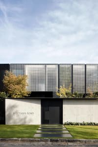 Concrete and metal exterior of a modern residential entryway with a minimalist design.