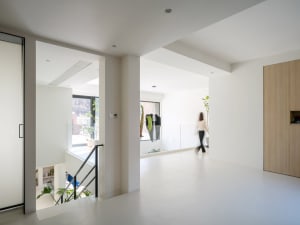 A minimalist house featuring concrete and glass interior design elements.