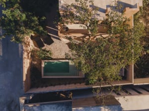 A modern terrace with concrete elements, featuring a pool and outdoor seating.