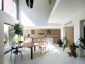 A modern living room with a concrete floor and large windows.