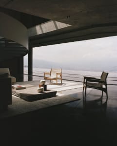 Modern minimalist living room featuring concrete and glass elements.