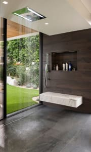 Modern minimalist bathroom featuring marble and glass elements.